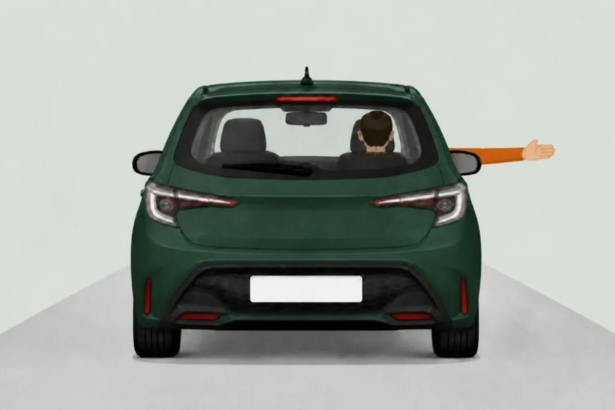 Driver's right arm held straight out of the window, seen from behind