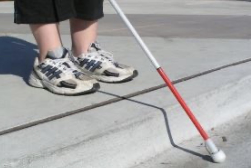 White cane with red band — deaf and visually impaired person
